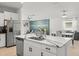 Bright open kitchen features a large island with a stainless steel sink and modern appliances at 9617 Branching Ship Trce, Wesley Chapel, FL 33545