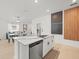 Open kitchen with a modern island, stainless steel appliances, and bright natural light at 9617 Branching Ship Trce, Wesley Chapel, FL 33545