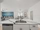 Bright open kitchen features a large island with a stainless steel sink and modern appliances at 9617 Branching Ship Trce, Wesley Chapel, FL 33545