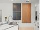 Close-up of kitchen with decorative wall panels, and stainless sink with a modern faucet at 9617 Branching Ship Trce, Wesley Chapel, FL 33545