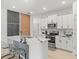 Modern kitchen with a large island, stainless steel appliances and decorative wall panels at 9617 Branching Ship Trce, Wesley Chapel, FL 33545