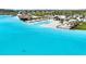 Overhead view of a resort-style lagoon with a sandy beach, tiki bars, gazebos and a refreshing swimming area at 9617 Branching Ship Trce, Wesley Chapel, FL 33545