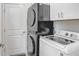 Efficient laundry area equipped with modern washer and dryer units and ample cabinet space at 9617 Branching Ship Trce, Wesley Chapel, FL 33545