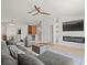 Bright living room featuring a fireplace, TV, and a view into the kitchen and dining area at 9617 Branching Ship Trce, Wesley Chapel, FL 33545