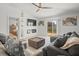 Open concept living room with a fireplace, ceiling fan, sliding doors, and comfortable seating at 9617 Branching Ship Trce, Wesley Chapel, FL 33545