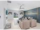 Spacious living room with modern decor, neutral walls, and a sliding glass door to the backyard at 9617 Branching Ship Trce, Wesley Chapel, FL 33545