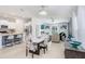Open-concept living room with abundant natural light, seamlessly connecting to the kitchen and dining area at 9617 Branching Ship Trce, Wesley Chapel, FL 33545