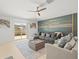 Well-lit living room features comfortable seating, modern decor, and a sliding glass door to the backyard at 9617 Branching Ship Trce, Wesley Chapel, FL 33545