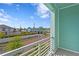 Balcony view overlooking a neighborhood street on a sunny day with vibrant blue skies at 98 29Th S St, St Petersburg, FL 33712