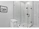 Modern shower stall featuring glass doors, white tile surround, mosaic tile flooring, and minimalist design at 98 29Th S St, St Petersburg, FL 33712