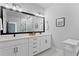 Elegant bathroom featuring double vanity, sleek black hardware, modern lighting, and tasteful décor at 98 29Th S St, St Petersburg, FL 33712