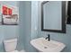 Powder room with pedestal sink, black faucet and black framed mirror at 98 29Th S St, St Petersburg, FL 33712
