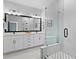 Stylish bathroom with a double vanity, a large mirror, modern lighting, and a glass-enclosed shower at 98 29Th S St, St Petersburg, FL 33712