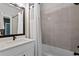 Bathroom with shower and tub featuring gray tiled wall and modern fixtures at 98 29Th S St, St Petersburg, FL 33712