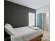 Bedroom featuring a black accent wall and ensuite bathroom at 98 29Th S St, St Petersburg, FL 33712