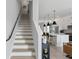 View of stairway and open kitchen with pendant lights at 98 29Th S St, St Petersburg, FL 33712