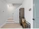 Inviting entryway with wood-look flooring, stairs, and modern accents like a storage cabinet and bench at 98 29Th S St, St Petersburg, FL 33712