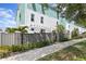 Stylish townhome exterior with modern siding, landscaped yard, a fence, and walkway at 98 29Th S St, St Petersburg, FL 33712