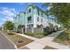 Charming townhomes with green and white exterior, landscaped yards, and sidewalk access on a sunny day at 98 29Th S St, St Petersburg, FL 33712