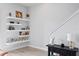 Hallway with floating shelves displaying art and decorative items at 98 29Th S St, St Petersburg, FL 33712