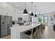 Open-concept kitchen featuring white cabinets, a large island and stainless steel appliances at 98 29Th S St, St Petersburg, FL 33712