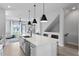 Contemporary kitchen island with sink and dishwasher, modern lighting, and sleek barstool seating at 98 29Th S St, St Petersburg, FL 33712
