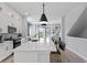 Bright kitchen with white cabinets, stainless steel appliances, an island with barstool seating, and modern pendant lights at 98 29Th S St, St Petersburg, FL 33712