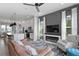 Spacious living area with modern kitchen, fireplace, large windows, and comfortable seating arrangement at 98 29Th S St, St Petersburg, FL 33712