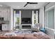 Open-concept living room showcasing a fireplace, large windows, stylish furniture, and seamless flow to the kitchen at 98 29Th S St, St Petersburg, FL 33712