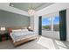 Elegant main bedroom featuring a wooden bed frame, stylish chandelier, and bright natural light at 98 29Th S St, St Petersburg, FL 33712