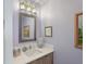 Powder room with framed mirror, modern lighting, and neutral decor at 100 1St N Ave # 1005, St Petersburg, FL 33701