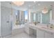 Modern bathroom with large window, soaking tub, glass shower, dual vanity, and contemporary lighting at 100 1St N Ave # 1005, St Petersburg, FL 33701