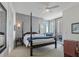 Bedroom featuring a four-poster bed, city views, and elegant decor at 100 1St N Ave # 1005, St Petersburg, FL 33701