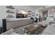 Open-concept living room with large TV, stylish furnishings, and view of kitchen area at 100 1St N Ave # 1005, St Petersburg, FL 33701
