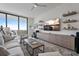 Comfortable living room with sleek entertainment center and balcony, perfect for relaxation and enjoying city views at 100 1St N Ave # 1005, St Petersburg, FL 33701