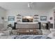 Bright living room featuring a ceiling fan, TV, modern shelving, and comfortable seating at 100 1St N Ave # 1005, St Petersburg, FL 33701