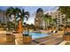 Resort-style swimming pool surrounded by lounge chairs, umbrellas, and tropical landscaping at 100 1St N Ave # 1005, St Petersburg, FL 33701