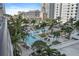 Aerial shot of a pool surrounded by palm trees, lounge chairs, and lush landscaping at 100 1St N Ave # 1005, St Petersburg, FL 33701