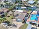 An aerial view shows this well-maintained waterfront home with lush landscaping and a brick driveway at 1012 Spindle Palm Way, Apollo Beach, FL 33572