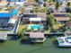 An aerial view highlights a waterfront home with a pool, dock, solar panels and boat access at 1012 Spindle Palm Way, Apollo Beach, FL 33572
