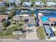 An aerial view showcases this waterfront home with a private boat dock, lush landscaping, and brick driveway at 1012 Spindle Palm Way, Apollo Beach, FL 33572