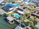 An aerial view of a beautiful waterfront home with a pool, a boat dock and beautiful landscaping at 1012 Spindle Palm Way, Apollo Beach, FL 33572