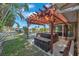 Backyard featuring a hot tub with pergola and a view of the water at 1012 Spindle Palm Way, Apollo Beach, FL 33572