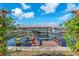 Waterfront home featuring a private boat dock and lift on a serene canal with lush greenery and sunny skies at 1012 Spindle Palm Way, Apollo Beach, FL 33572