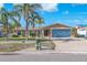 Charming single story home with a blue garage door and a well-manicured front yard at 1012 Spindle Palm Way, Apollo Beach, FL 33572