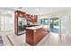 Modern kitchen featuring wood cabinets, stainless steel appliances, and a marble top island at 1012 Spindle Palm Way, Apollo Beach, FL 33572