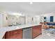 Spacious kitchen with marble countertops, stainless steel appliances, and an open layout to the living room at 1012 Spindle Palm Way, Apollo Beach, FL 33572