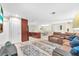 Open-concept living space showing tiled flooring, a large sectional couch, and access to the kitchen at 1012 Spindle Palm Way, Apollo Beach, FL 33572