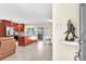 Open-concept living space with tiled flooring, cherry cabinets, stainless appliances, and sliding glass doors to lanai at 1012 Spindle Palm Way, Apollo Beach, FL 33572