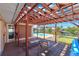 Cozy covered patio overlooking a sparkling pool and canal views, perfect for outdoor relaxation at 1012 Spindle Palm Way, Apollo Beach, FL 33572